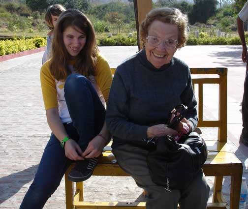 Carly and Horty putting on their shoes at Ranakapur Jain Temple.