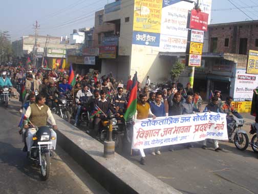 Large group of men walking down the road with banners, a political demonstration.