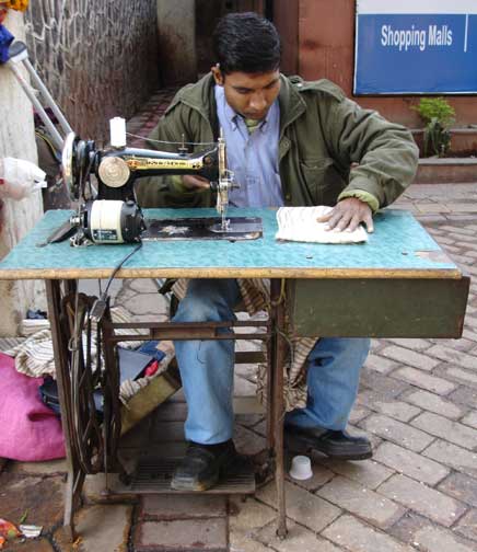 Sewing with old Singer machine in Delhi.